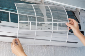 A person checking the aircon’s air filter | Gibber Services