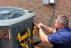 A technician checking the power of the aircon’s outdoor unit | Gibber Services