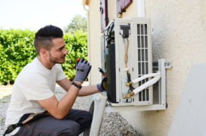 A person who checks the air conditioning unit to keep it running smoothly | Gibber Services