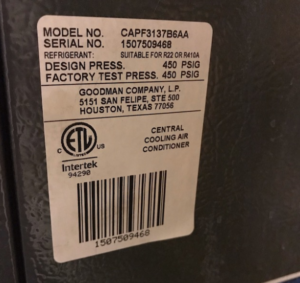 An HVAC furnace sticker with its model and serial numbers