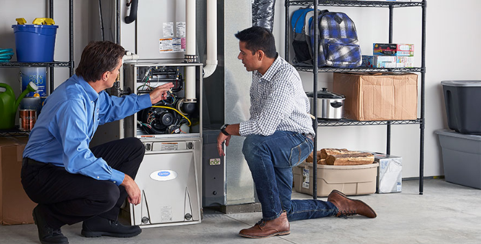 HVAC technicians checking the furnace at home